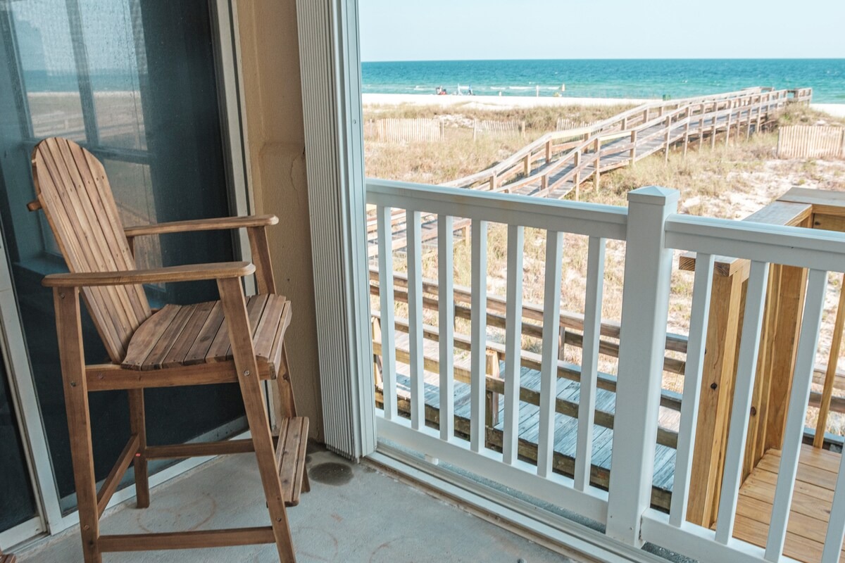 Covered balcony seating with immediate Gulf-facing orientation.